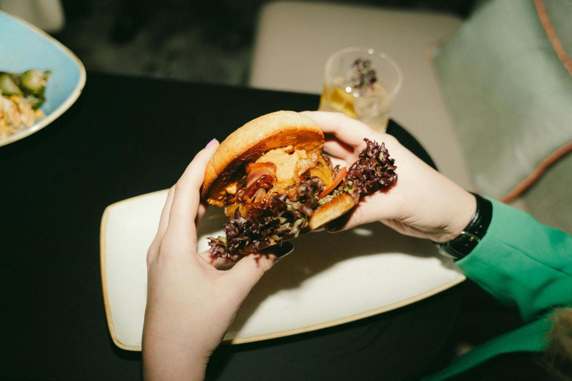 Renaissance Hamburg Hotel Bagian luar foto A burger being held in the hand